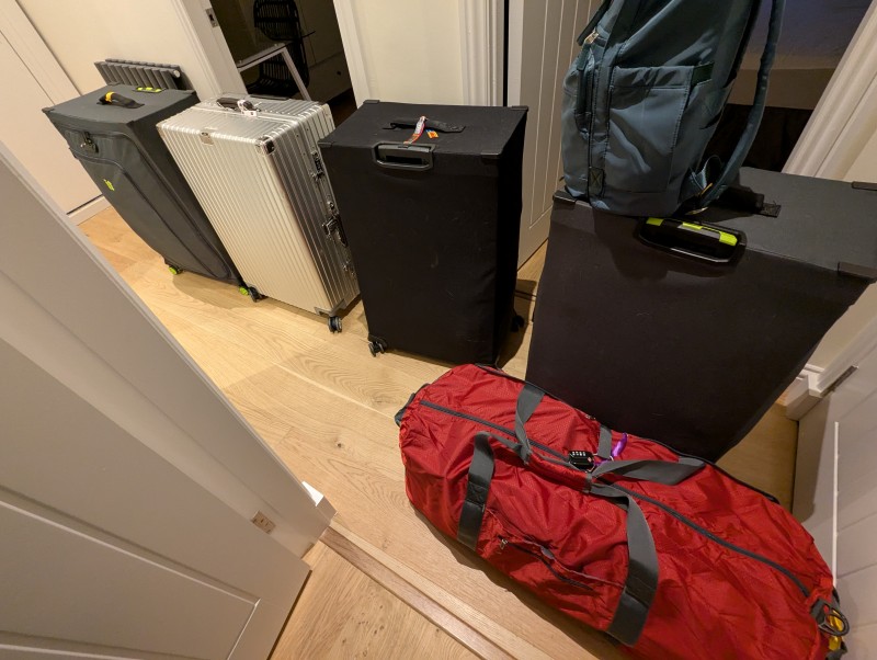 Five suitcases and a backpack